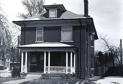 Black and white photo of a Foursquare style house.